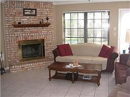 This cozy family room is the heart of the home. Corner wood burning fireplace, large window and Fren