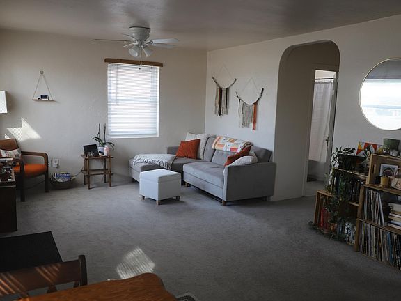 The living area has plenty of sunlight. New window treatments and newer carpeting.