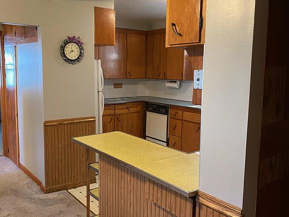 Dining area to kitchen. New kitchen countertops, flooring and fixtures coming