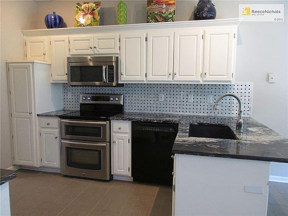 Updated Kitchen with SS Glass Top Range with Double Oven, SS Microwave, Granite, Granite Composite Sink, Long-Neck Faucet, Rollouts in Pantry