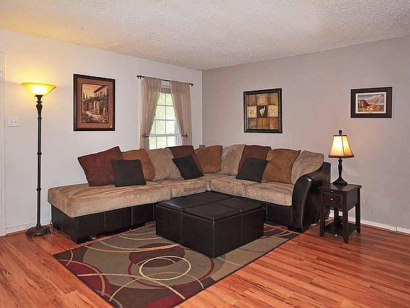 Living room with laminate flooring and neutral paint.
