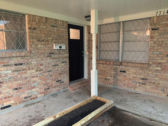 Long L-shaped Front Porch with flower bed boarders ready for your favorite flowers