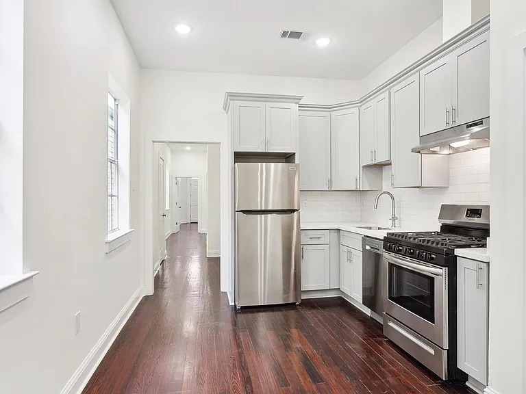 Kitchen with new stainless steel appliance and gas range