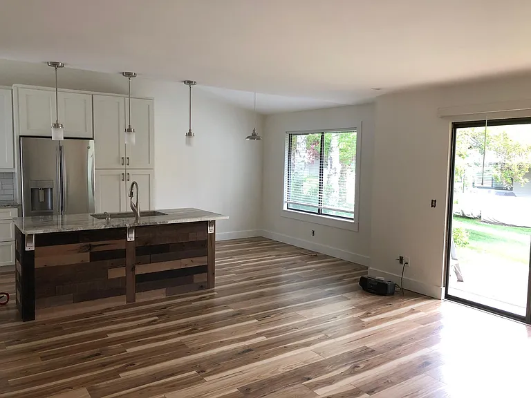 Open layout with many options for furniture. Island has overhanging bar on this side with ample counter for eating.