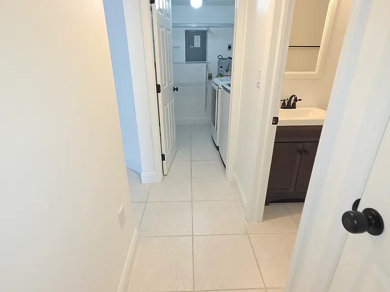 Hall with laundry room and guest bathroom.