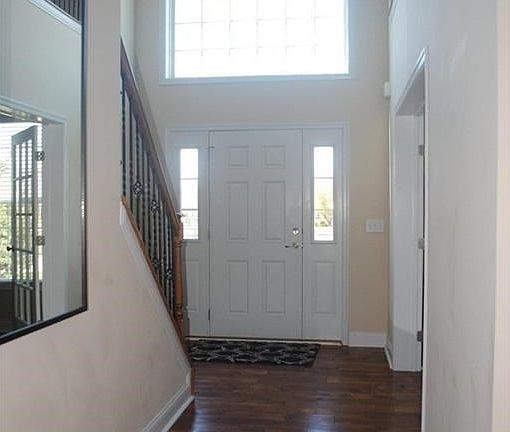 Soaring, dramatic & open entry with new handscraped, hickory wood floors.