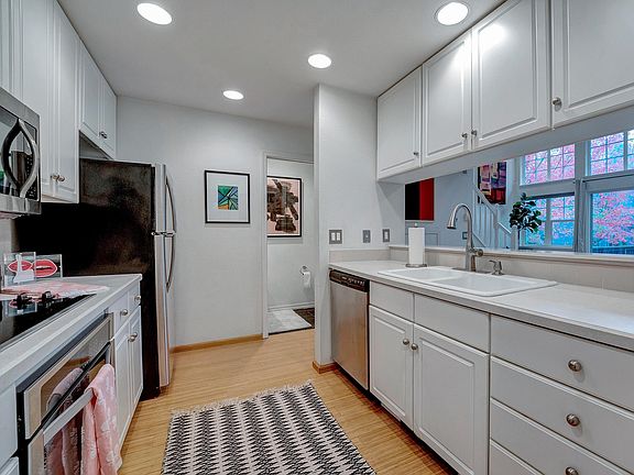 Lovely kitchen has enjoyed recent upgrades. Stove, Microwave, Refrigerator and Dishwasher included. Sink looks out to deck view