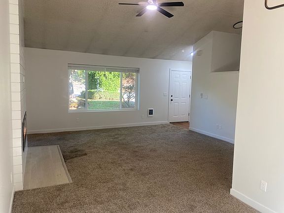 The entry greets you & your guests with a coat closet, large picture window, vaulted ceilings & an open concept floor plan.