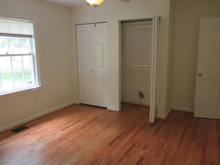 Front bedroom, louvered door closet. Additional closet on right side