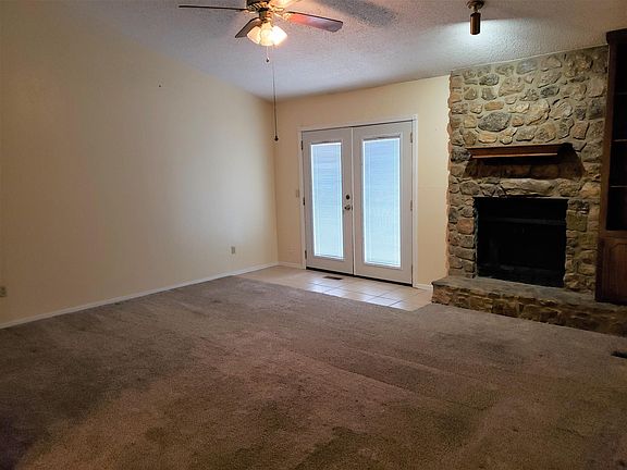 Livingroom view 2, ceiling fan, fireplace