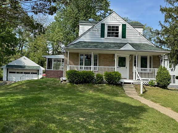 Front of House with View of Side Porch and Detached 2 Car Garage
