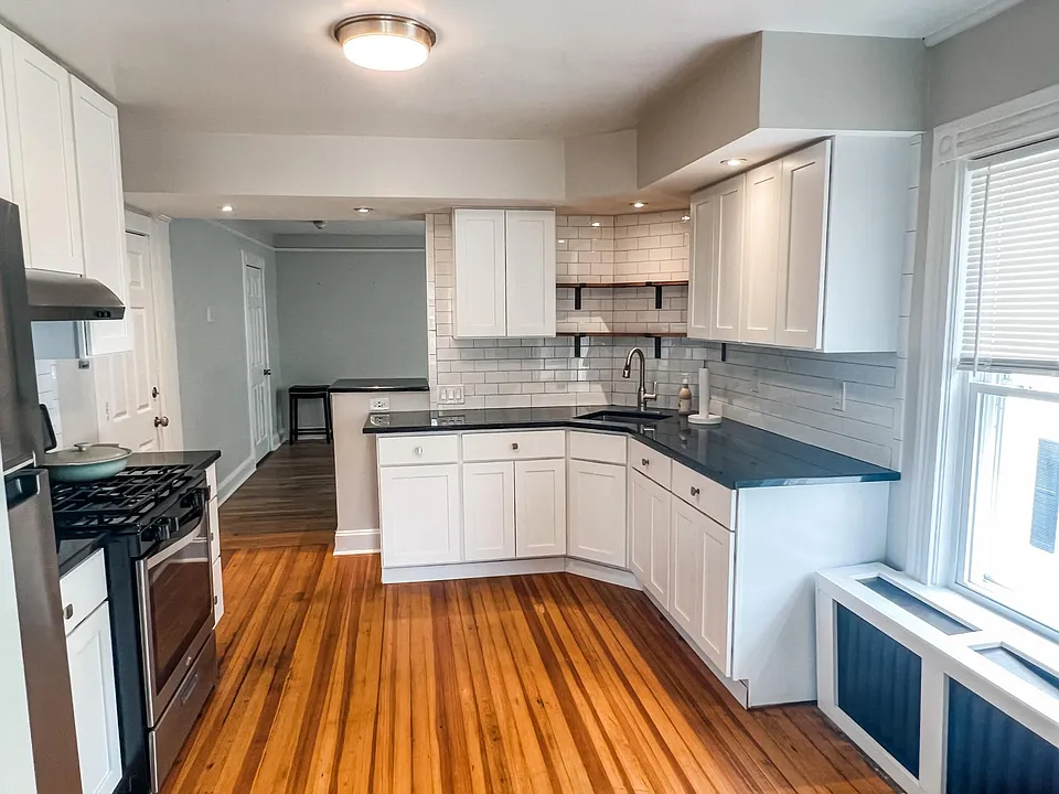 Oversized kitchen with granite counters and farm house finishes