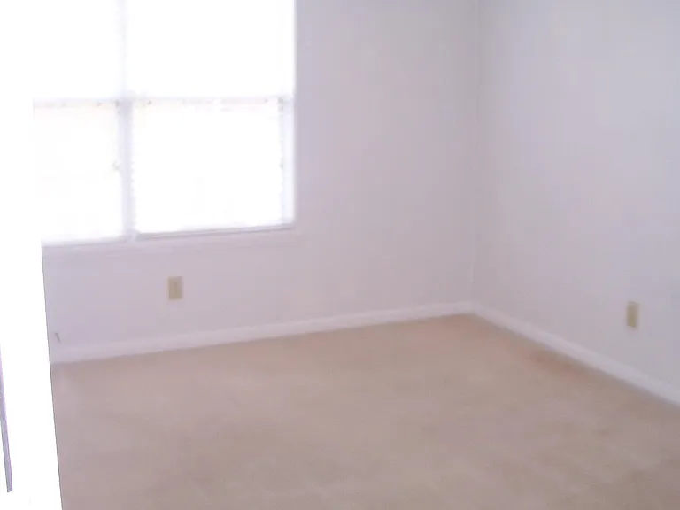 OLDER PHOTO - UPDATED PAINT/FLOORING -Bedroom with ceiling fan.