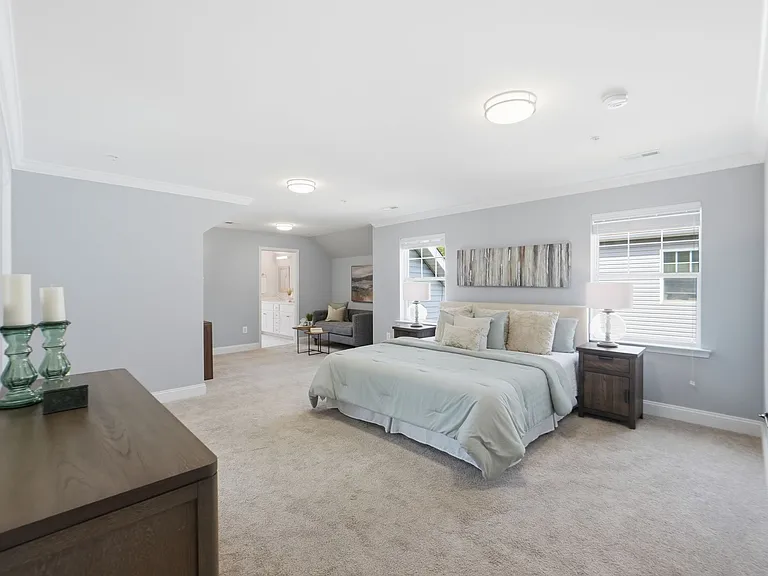 Master bedroom with sitting area, massive walk-in closet, and custom spa-like en-suite with soaking tub.