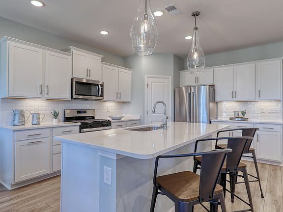 Luxurious Kitchen with Stainless Steel Appliances and Tile Backsplash