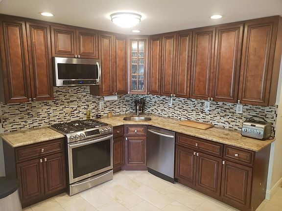 Kitchen w/ all stainless steel appliances, tall cabinets, and granite counters!
