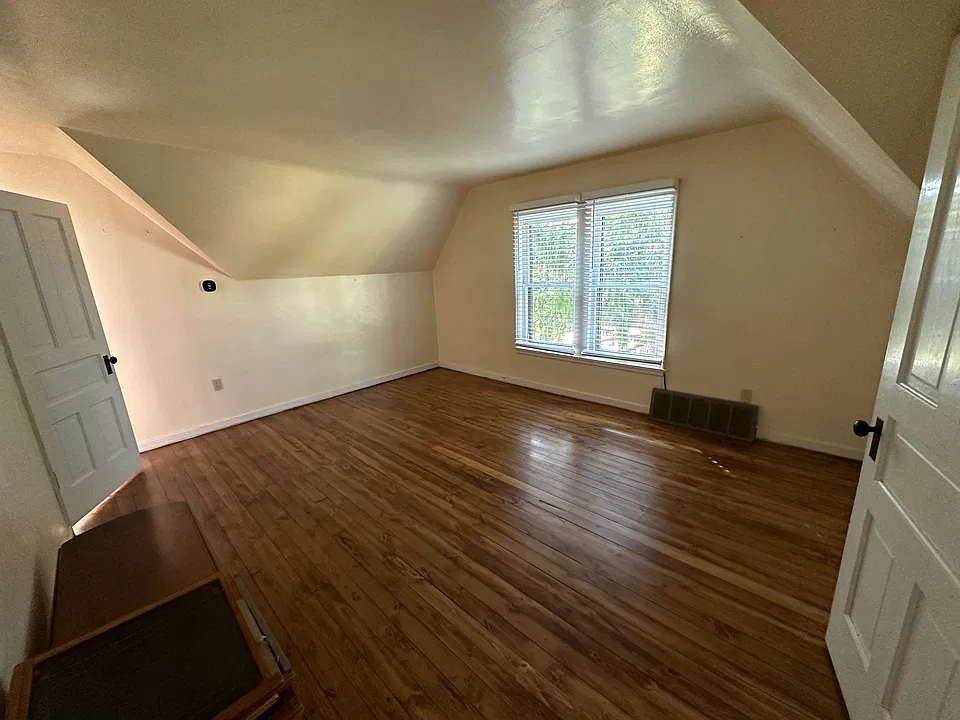 Large living room with wood floors.
