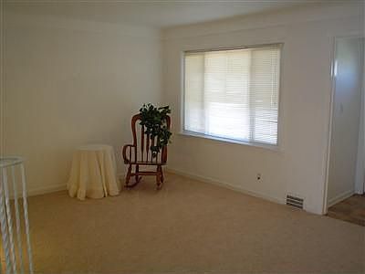THE LIVING ROOM FEATURES AN ENTRY FOYER WITH CLOSET AND LARGE PICTURE WINDOW.