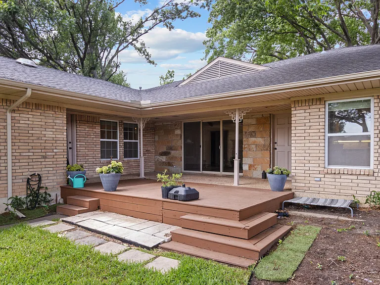 Wonderful covered patio with deck overlooking backyard.