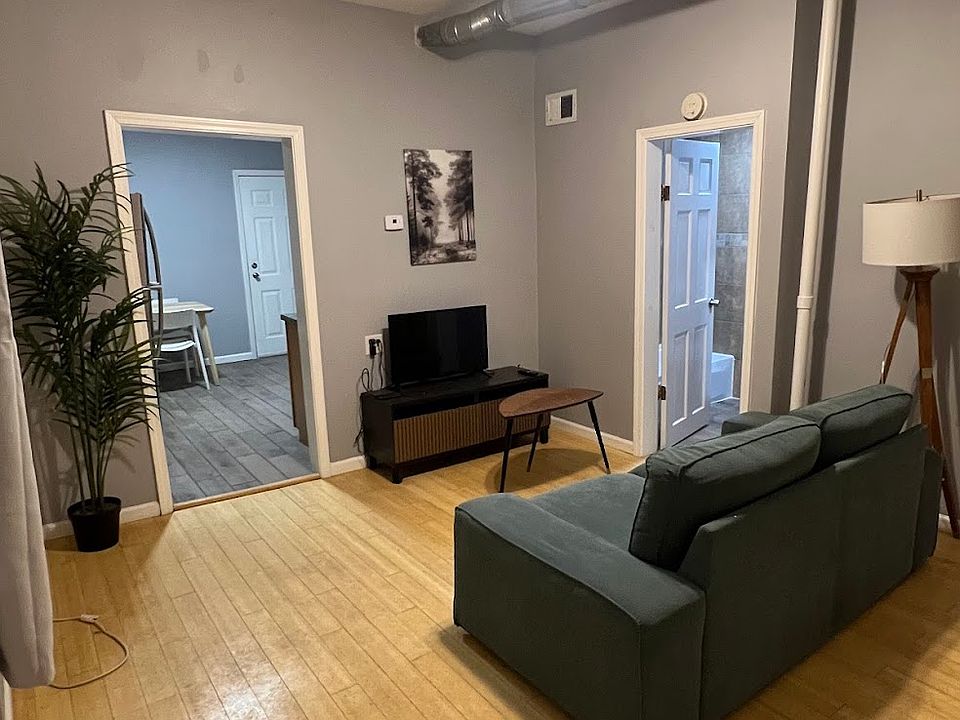 Living Room, couch, coffee table, tv, tv table, plant, painting and lamp included
