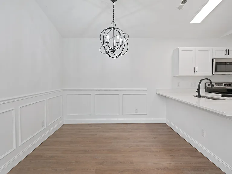 Experience the charm of this elegant dining space linked to a modern kitchen setup, perfect for entertaining. Experience the charm of this elegant dining space linked to a modern kitchen setup, perfect for entertaining.