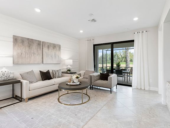 Model Representation Open gathering room with sliding glass doors to a covered lanai
