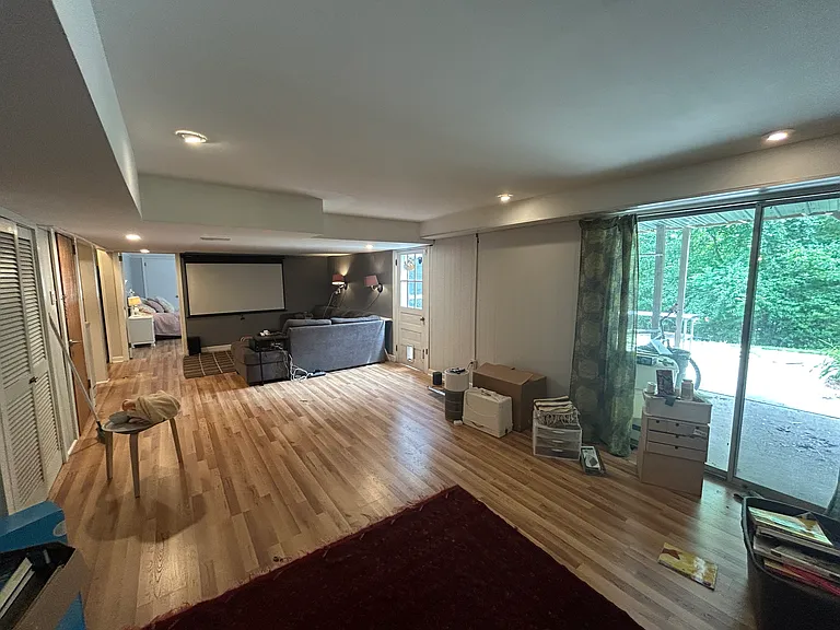 lower level - sprawling bonus space including TV area and music room. Sliding door and swing door to backyard.