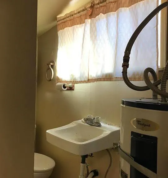 Partial view of bathroom. Outside of this room is large parking lot for neighboring condos. Nice & quiet.