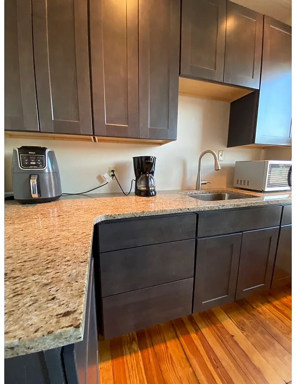 New rich grey cabinets with granite counters. Refrigerator, gas stove and microwave included. - 1051 W 4th St #2-1
