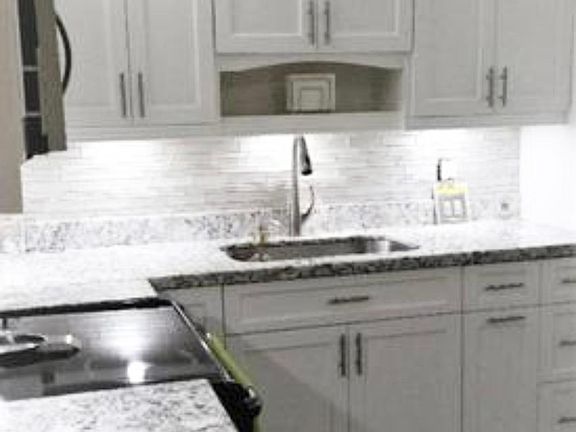 Granite countertops, stainless steel sink, garbage disposal, and designer lighting. Pantry, built-in microwave and oven. Washer/Dryer.