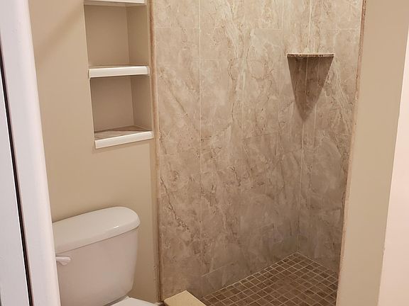 bathroom with tiled shower