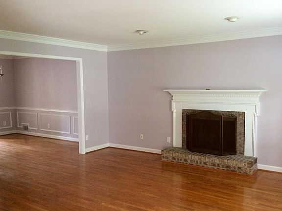 LIVING ROOM VIEWED FROM THE INTERIOR FOYER LARGE OPENING LEADS TO DINING ROOM