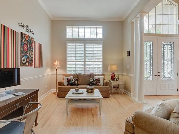 Living Room with plantation shutters and pocket doors to family room