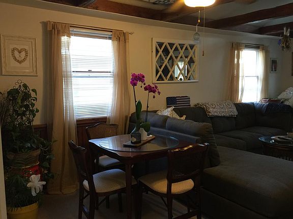 dining area w/ valeted ceiling and wood beams