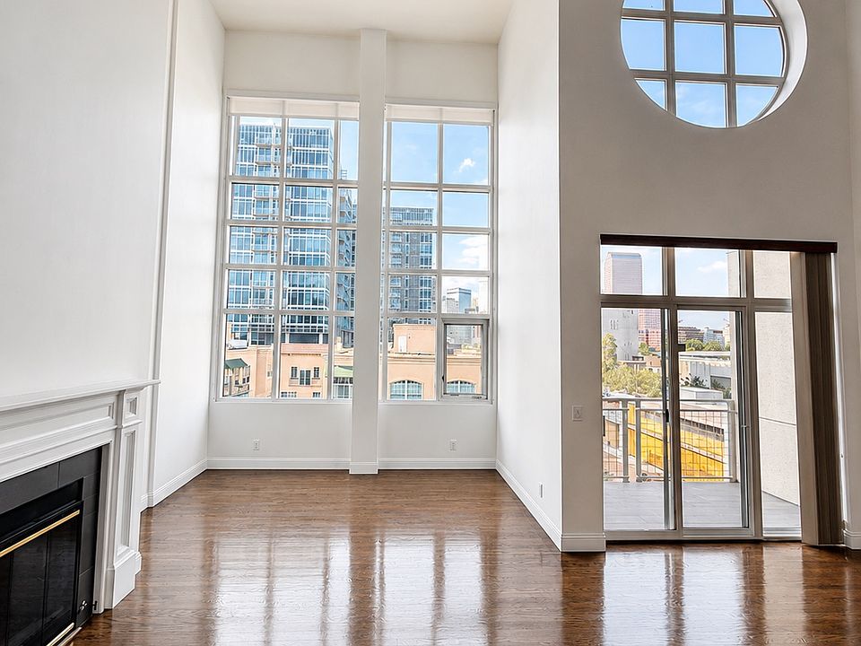 Spacious main living area with soaring ceilings and beautiful hardwood floors.