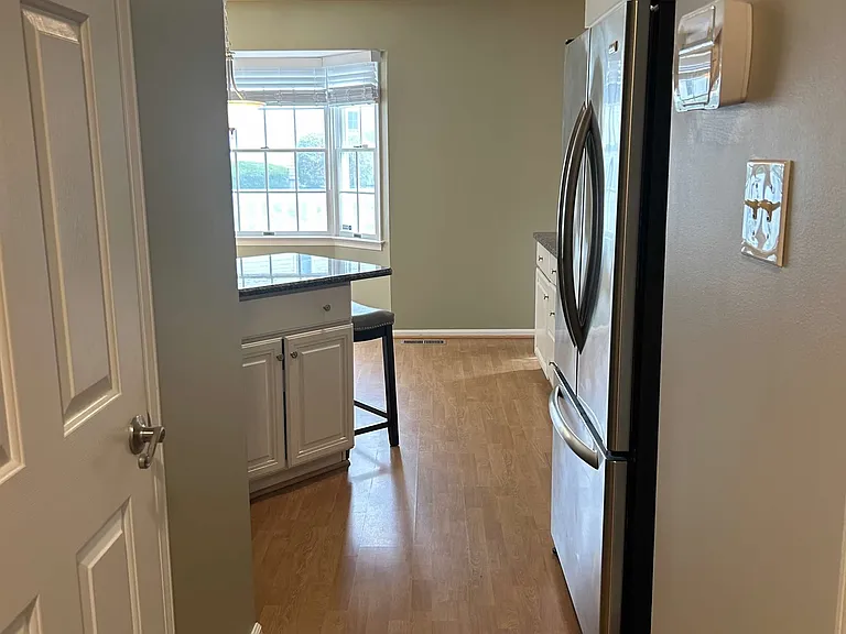 entrance to kitchen, half bath on left
