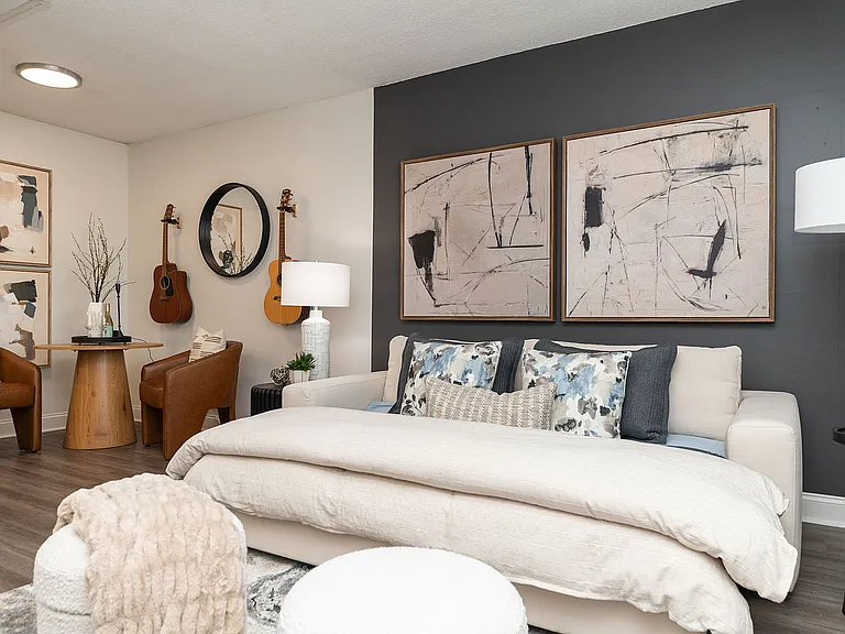 Spacious open living & sleeping area with hardwood-style flooring