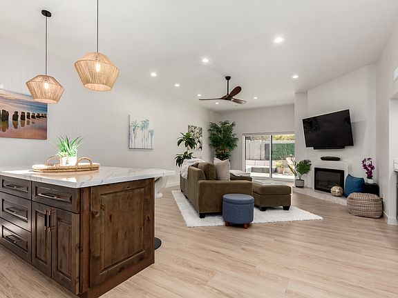 View as you walk into foyer: open living concept with 10' flat ceilings and canned lighting on dimer switches throughout!