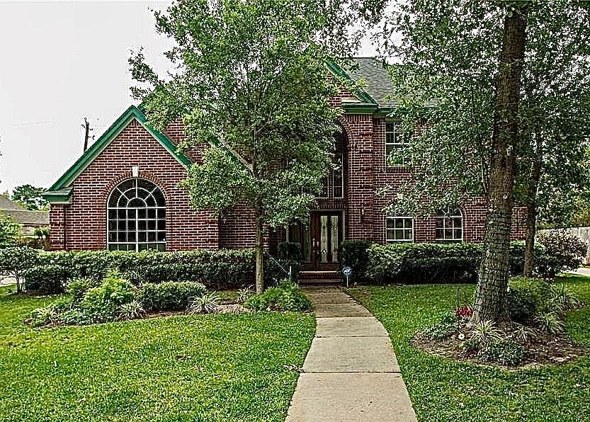 3652 Blue Lake is a beautiful 2-story brick home on a quiet street in Cypresswood It has beautiful palladium windows with brickwork accents
