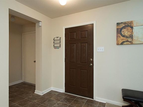 Entry way with hall closet and half bath to the right