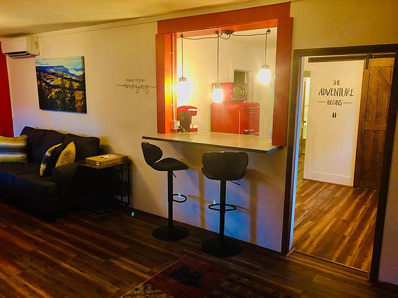 The sitting bar, living room, and kitchen pass through.