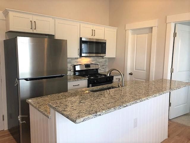 Stainless appliances and granite countertops in this pretty kitchen