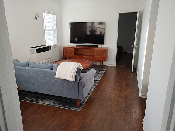 Large living room with furnace (that works great!) and recessed lighting. New laminate flooring.