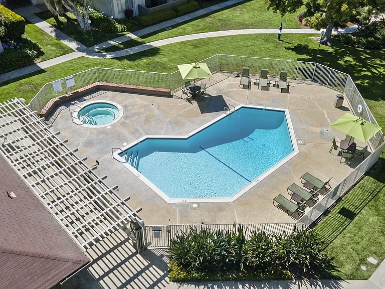 Aerial view of community pool and spa at Strada Apartments in Orange, CA