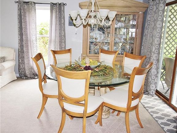 Dining in this dining room is a delight with a beautiful chandelier and access to the wrap around deck.