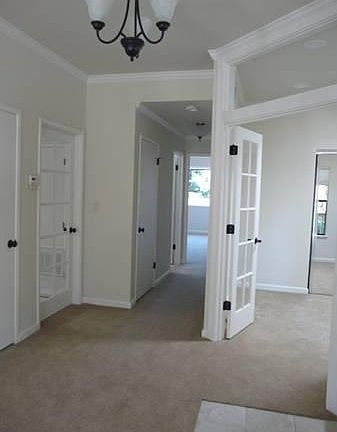 Crown molding throughout 9 foot ceilings. Office/3rd bedroom has French doors and a custom glass transom.