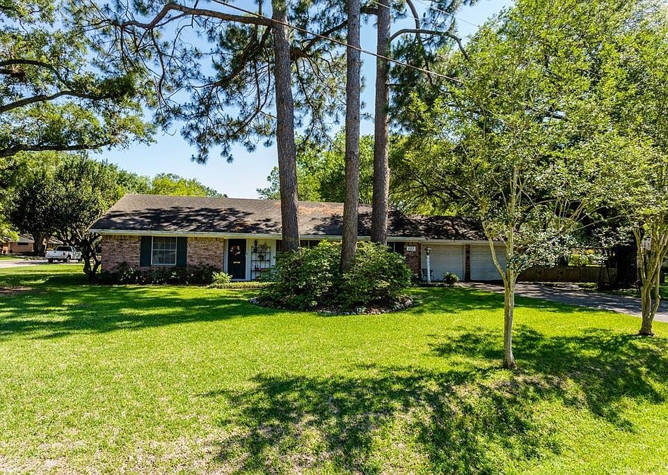 This charming, one-story, ranch style home sits on a large corner lot with mature landscaping and trees.