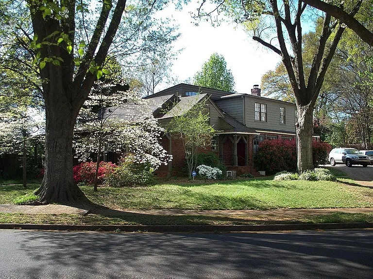 Two Story House showing Side Entrance, next to Parking Area large enough for four cars.