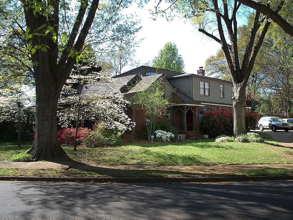 Two Story House showing Side Entrance, next to Parking Area large enough for four cars.