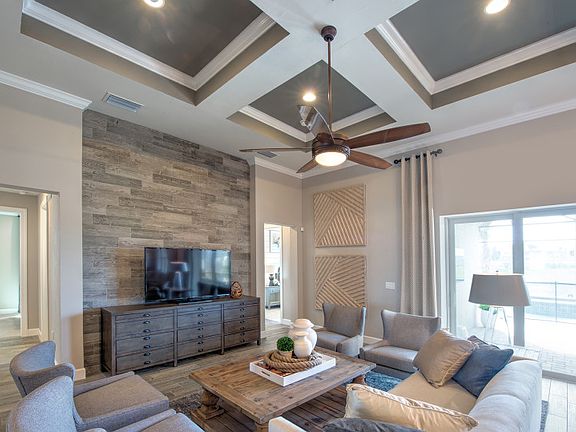 Model Representation Gathering room with decorative coffered ceiling and sliding glass door to the